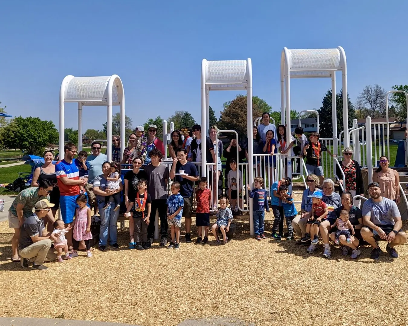 Group photo of Dharma School families and teachers at a playground