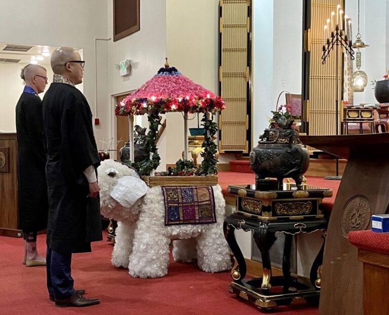 The Hanamatsuri special service observed by Senseis Hayashi and Thompson in front of the ceremonial white elephant.